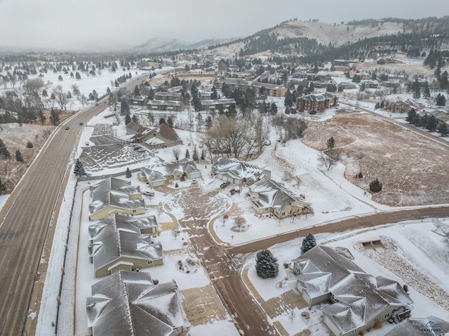 snowy aerial view featuring a mountain view