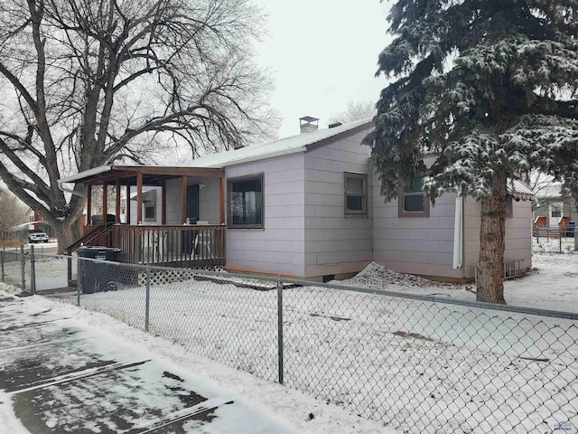 view of snow covered rear of property