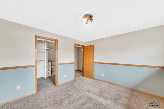 unfurnished bedroom featuring a closet and carpet flooring