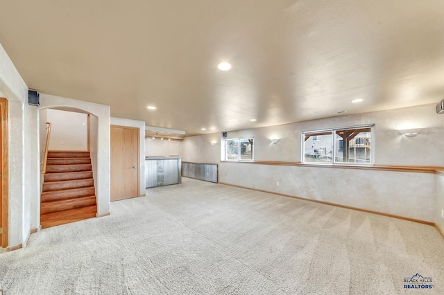 basement featuring light colored carpet