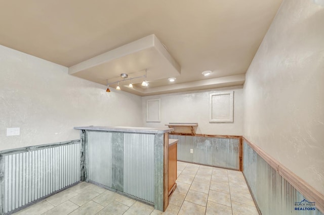 kitchen with light tile patterned flooring and kitchen peninsula