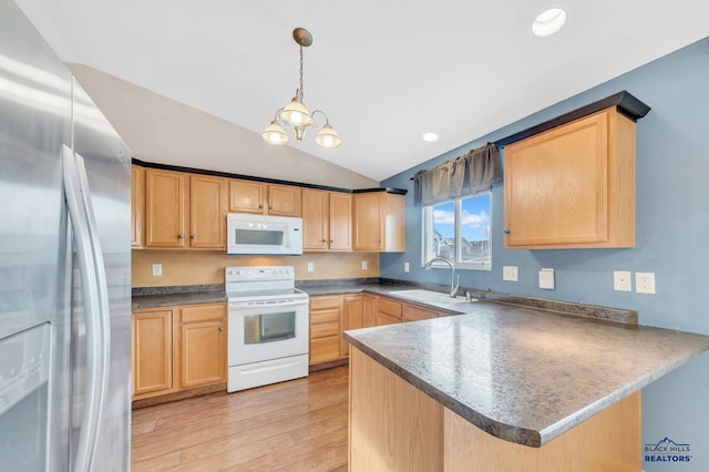 kitchen featuring sink, white appliances, light hardwood / wood-style flooring, hanging light fixtures, and kitchen peninsula