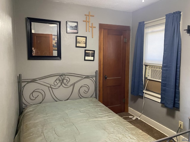 bedroom with cooling unit and a textured ceiling