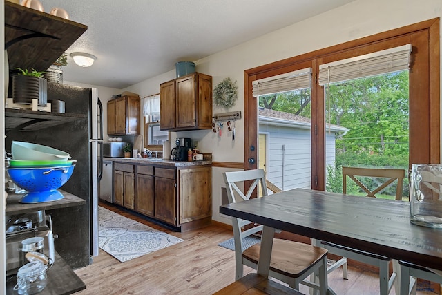 kitchen featuring sink, light hardwood / wood-style flooring, and a textured ceiling