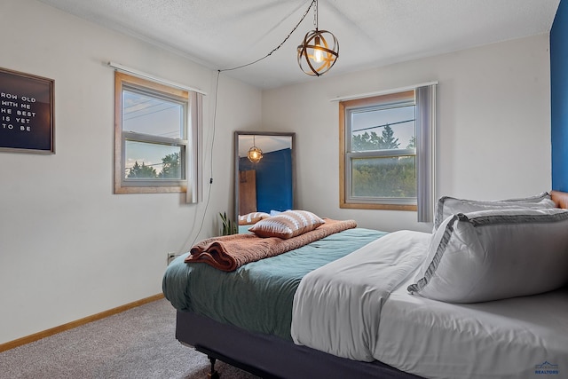 bedroom with carpet flooring and a textured ceiling