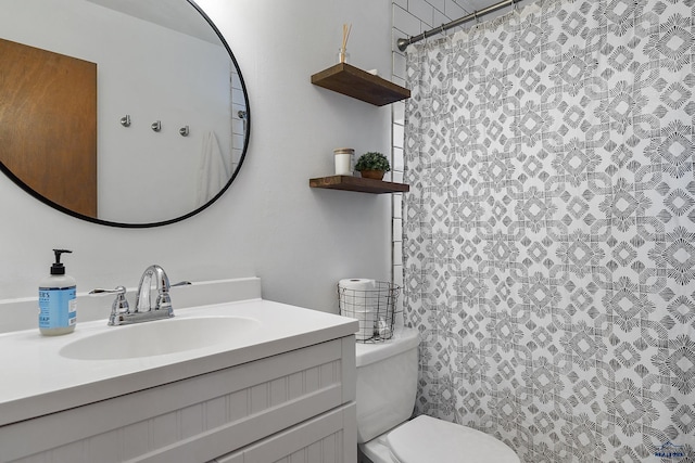 bathroom with vanity, a shower with shower curtain, and toilet