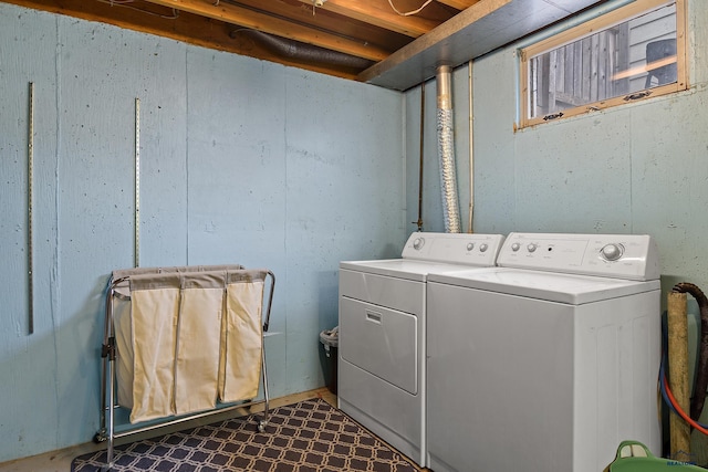 clothes washing area with separate washer and dryer