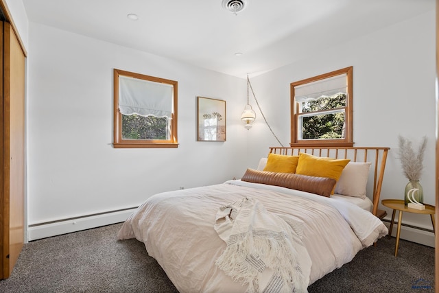 carpeted bedroom with a baseboard radiator and a closet