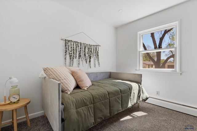 bedroom featuring dark carpet and a baseboard heating unit