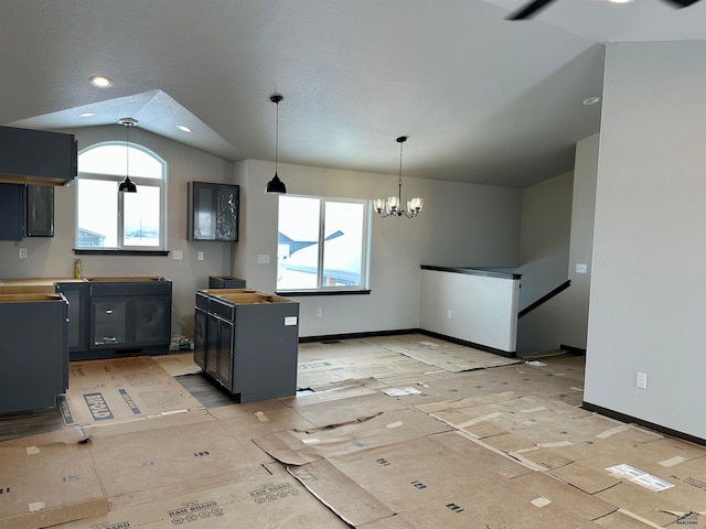 kitchen with wooden counters, vaulted ceiling, and a notable chandelier