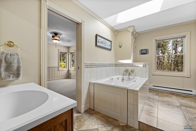 bathroom with a washtub, sink, a skylight, a textured ceiling, and a baseboard radiator