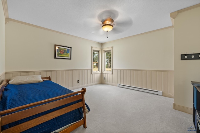 carpeted bedroom with a baseboard heating unit, crown molding, a textured ceiling, and ceiling fan