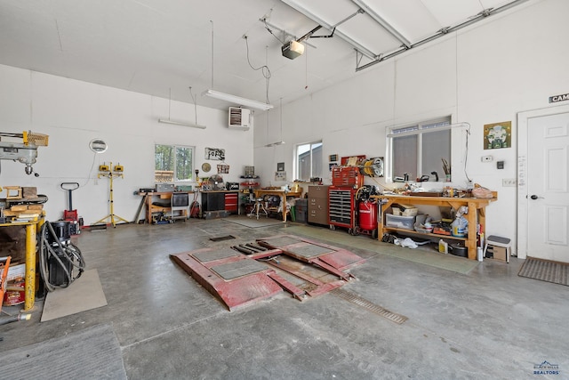 garage with a garage door opener and a workshop area