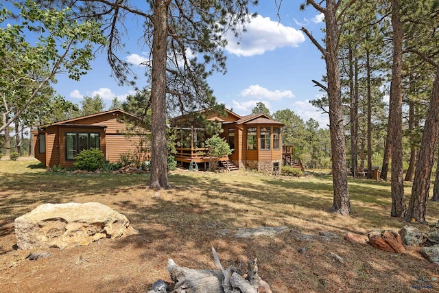 view of yard with a sunroom and a deck