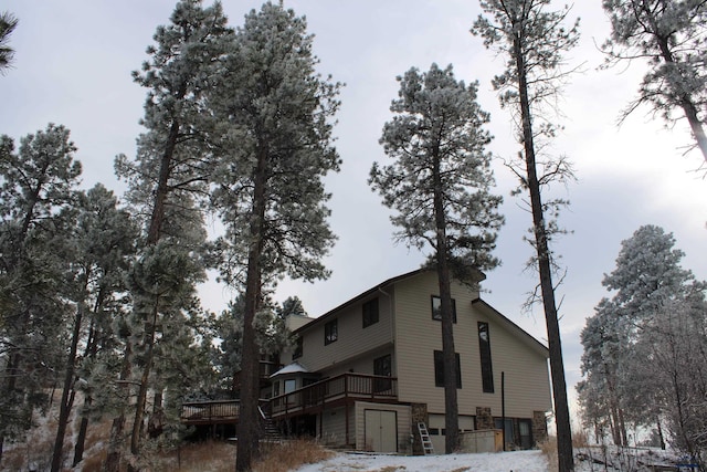 view of home's exterior with a garage and a deck