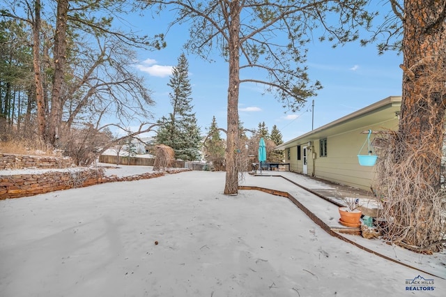 view of yard layered in snow