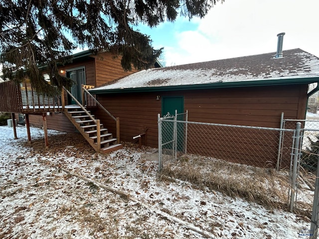 view of snow covered rear of property