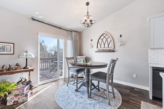 dining area with an inviting chandelier, vaulted ceiling, and dark hardwood / wood-style floors