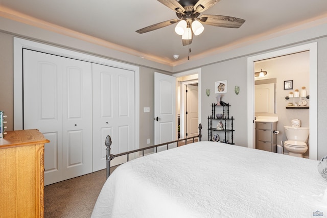 bedroom featuring ceiling fan, carpet flooring, ensuite bath, and a closet