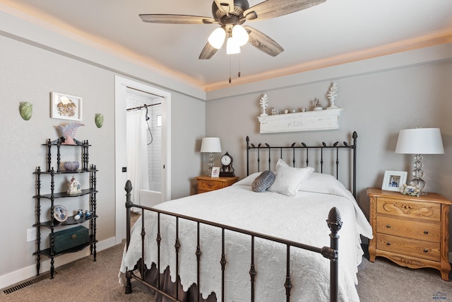 bedroom featuring connected bathroom, ceiling fan, and carpet