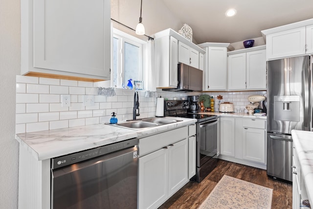 kitchen featuring dark wood-type flooring, sink, hanging light fixtures, stainless steel appliances, and white cabinets