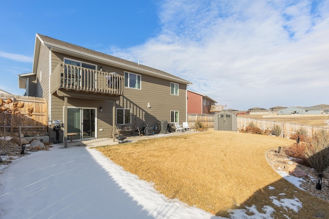 back of house with a balcony, a patio area, and a storage unit