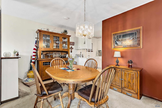 carpeted dining space featuring an inviting chandelier