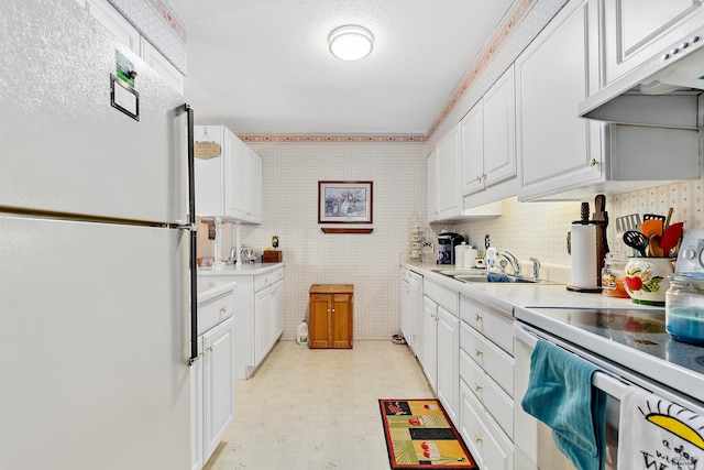 kitchen featuring white cabinetry, white appliances, and sink