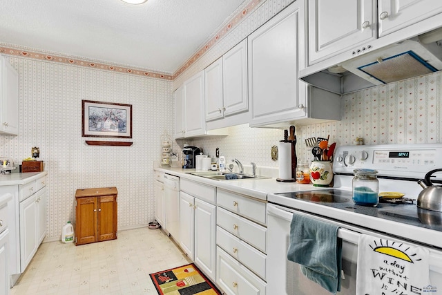 kitchen with sink, a textured ceiling, white cabinets, and white appliances