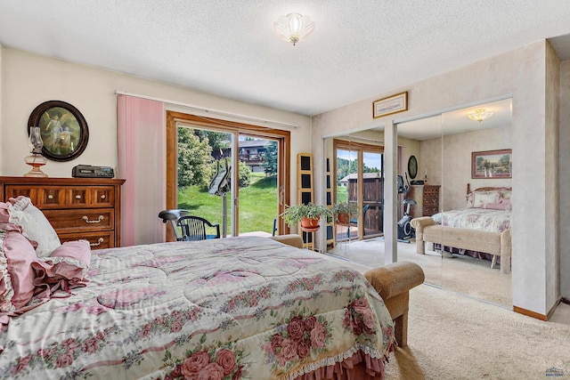 carpeted bedroom with access to exterior and a textured ceiling