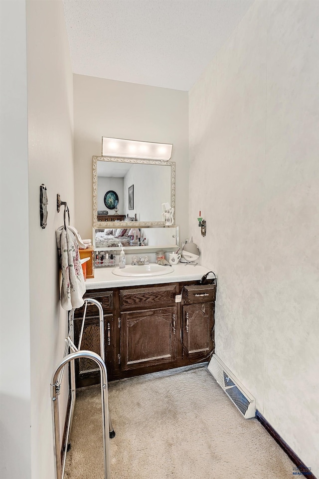 bathroom with vanity and a textured ceiling