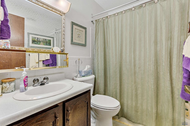 bathroom featuring vanity, tile walls, walk in shower, and toilet