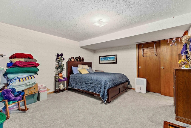 carpeted bedroom featuring a textured ceiling