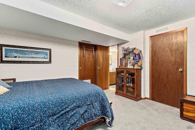 bedroom with a textured ceiling and carpet