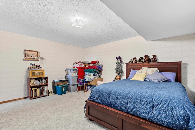 bedroom featuring carpet flooring and a textured ceiling