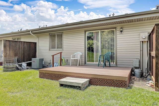 back of house with a yard, cooling unit, and a deck