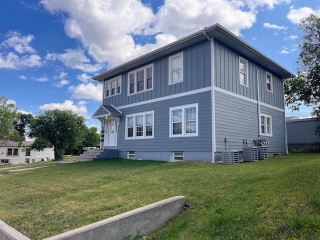 view of property exterior with cooling unit and a yard