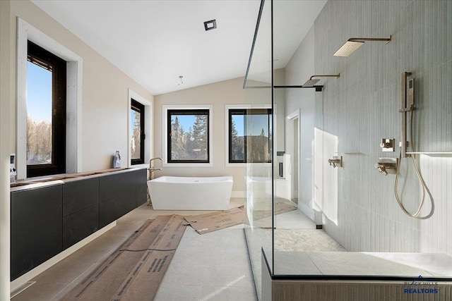 bathroom with shower with separate bathtub, vaulted ceiling, and vanity