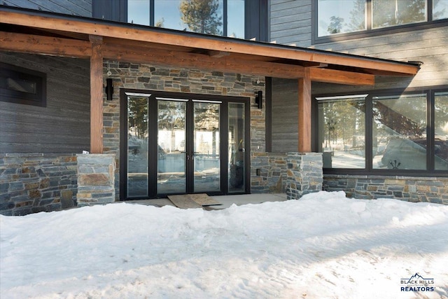 view of snow covered property entrance