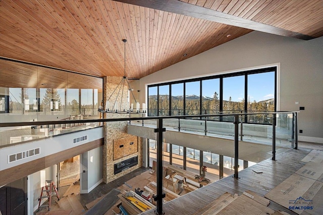 interior space featuring lofted ceiling, a healthy amount of sunlight, and wood ceiling