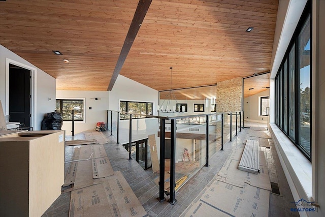 corridor with wood ceiling and high vaulted ceiling