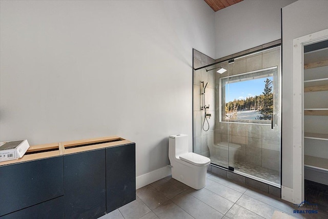 bathroom with walk in shower, tile patterned floors, and toilet