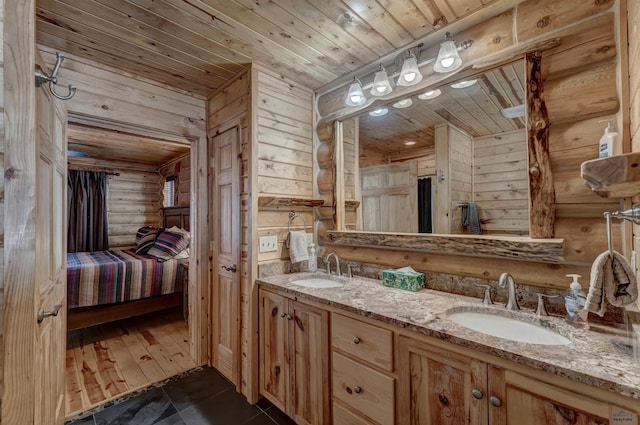 bathroom with vanity, rustic walls, and wooden ceiling