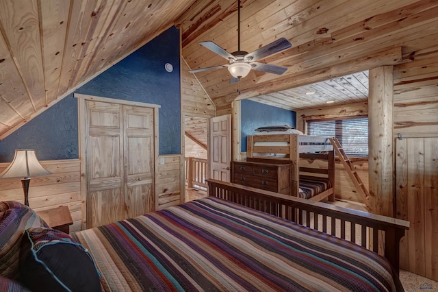 bedroom with vaulted ceiling, wood ceiling, and wood walls
