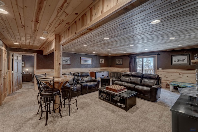 carpeted living room featuring wooden ceiling and wood walls