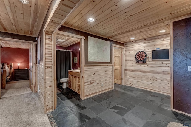 interior space with wooden ceiling and wood walls