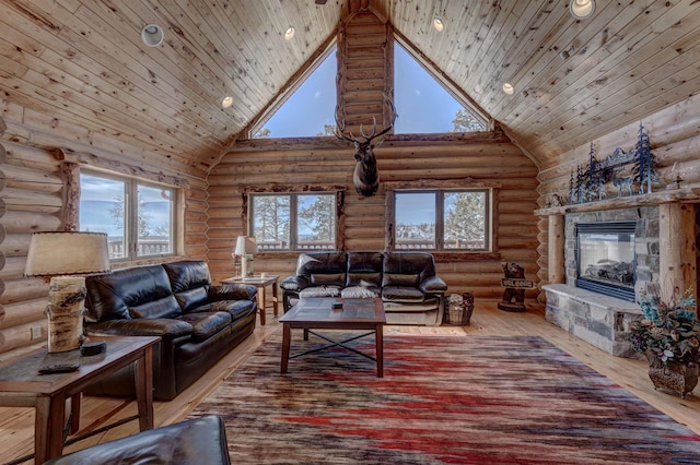 living room with hardwood / wood-style flooring, a stone fireplace, high vaulted ceiling, and wooden ceiling