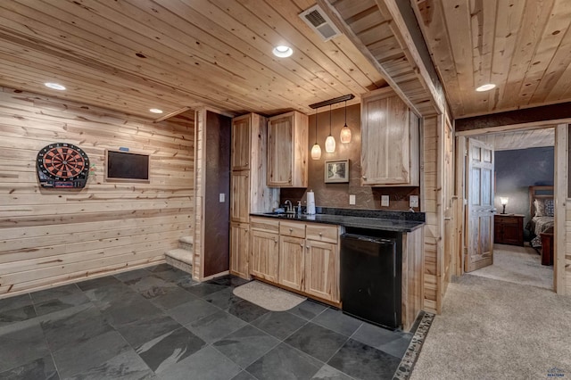 kitchen with wood ceiling, wooden walls, black dishwasher, and hanging light fixtures