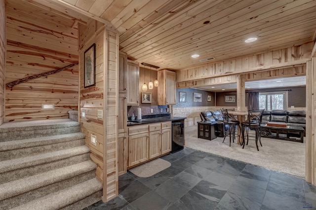 kitchen featuring wood walls, light brown cabinets, wooden ceiling, black dishwasher, and pendant lighting