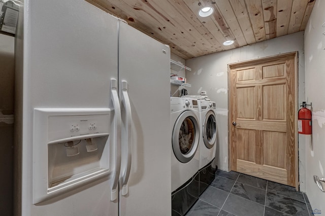 washroom featuring washing machine and dryer and wooden ceiling